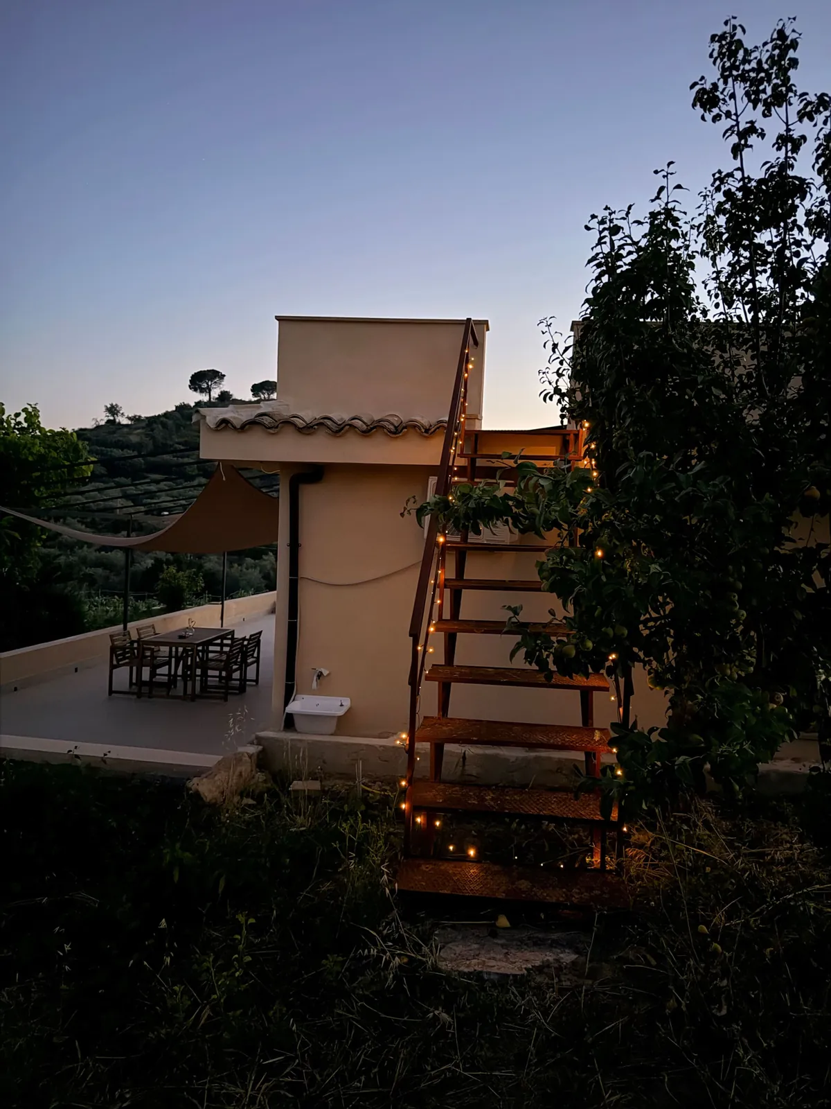 La casa al tramonto, con le lucine sulla scala esterna